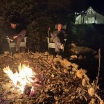 Campfire scene with marshmallows & laughter around solo stove