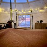 Sunlight filtering through canvas walls with nature outdoors